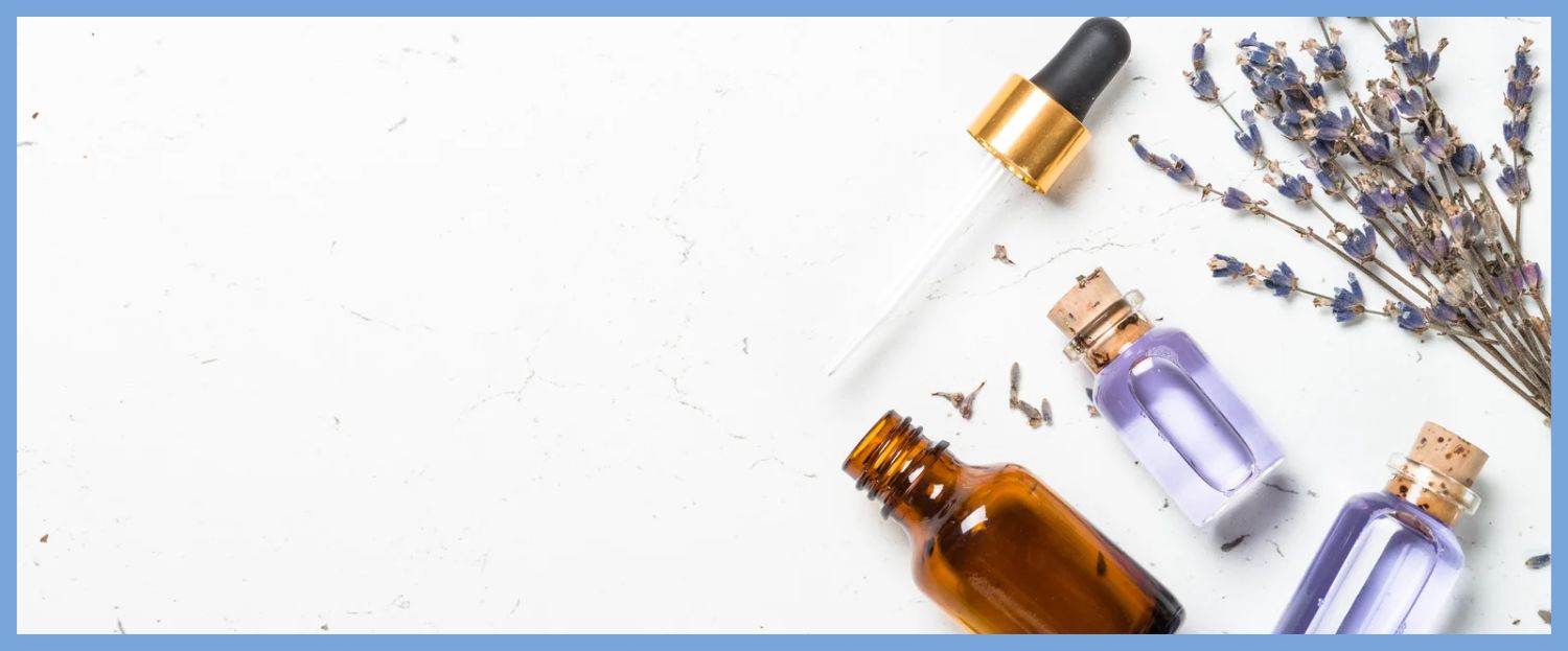 Lavender oil and pipette laying flat on a table