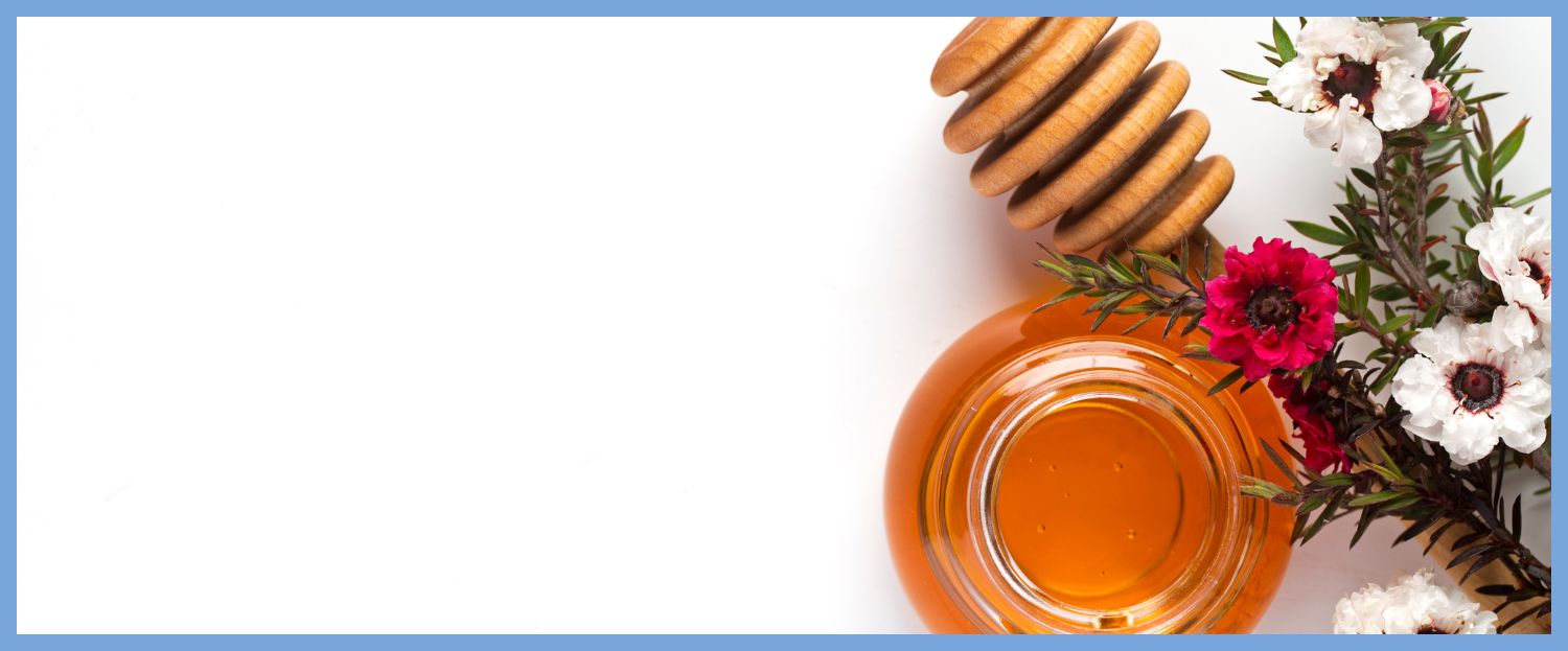 top down view of honey jar and wooden dipper