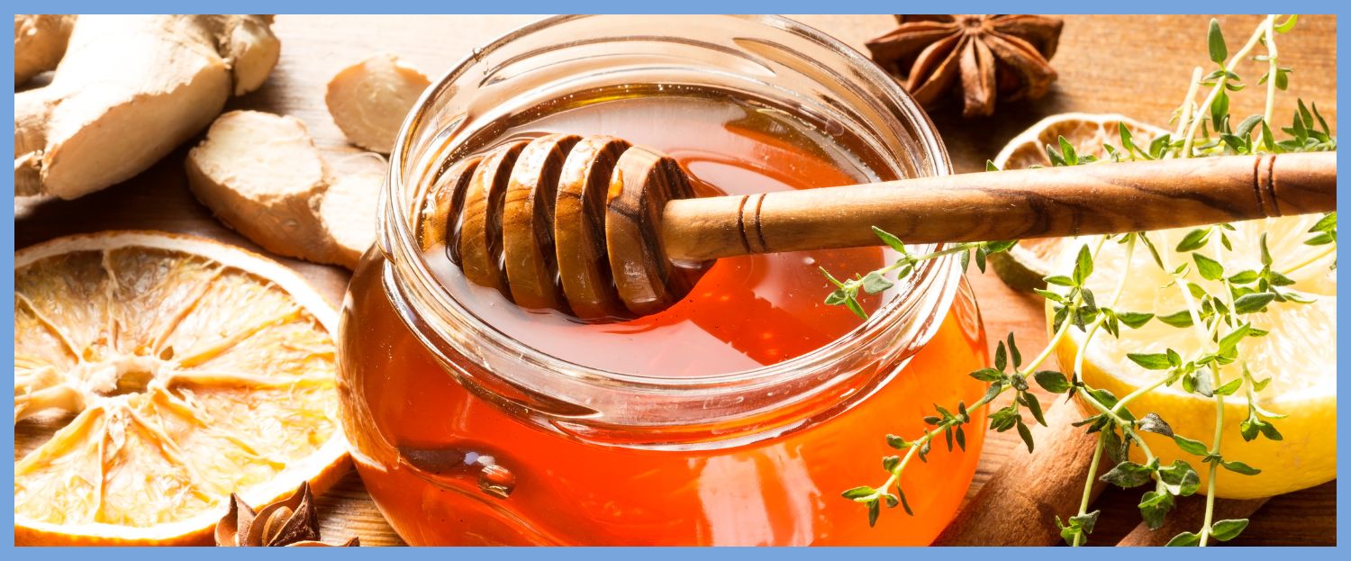honey in a jar with a wooden dipper resting on top